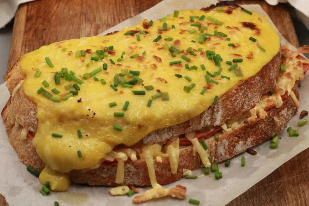 This vegan croque monsieur is utterly delicious. Made with a crusty sourdough bread, sandwiching layers of melted vegan cheese, vegan ham, with creamy grilled top. 