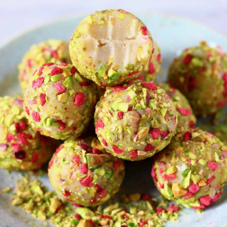 Vegan pistachio coconut truffles with pink and green toppings, delicious plant-based dessert.