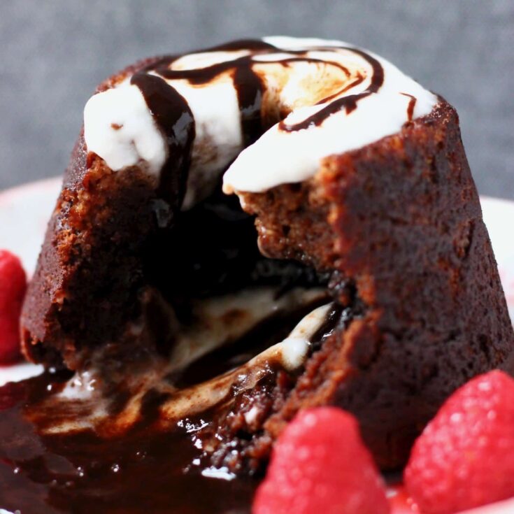 Delicious vegan chocolate lava cake with strawberries and melted chocolate center.
