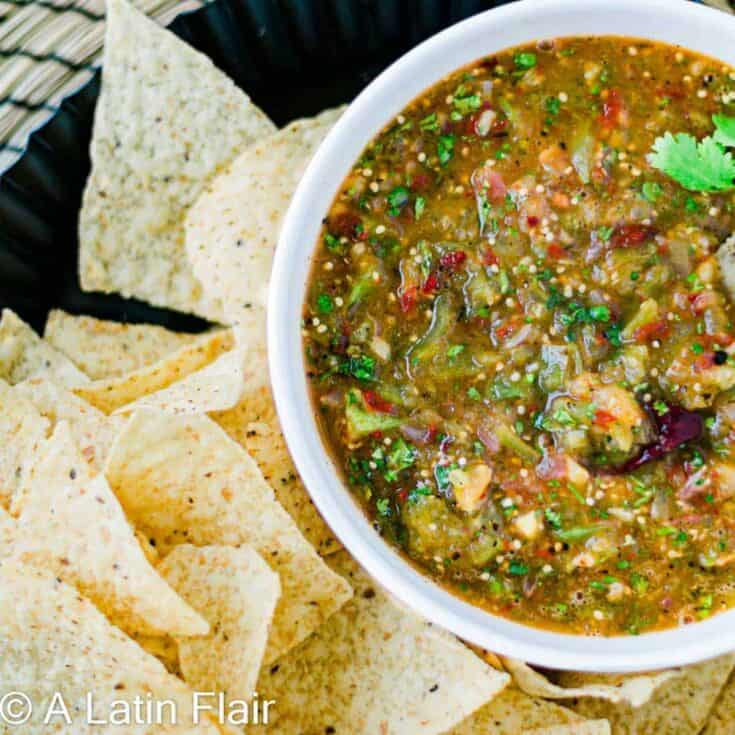 Vegan salsa with fresh herbs and vegetables served with tortilla chips.