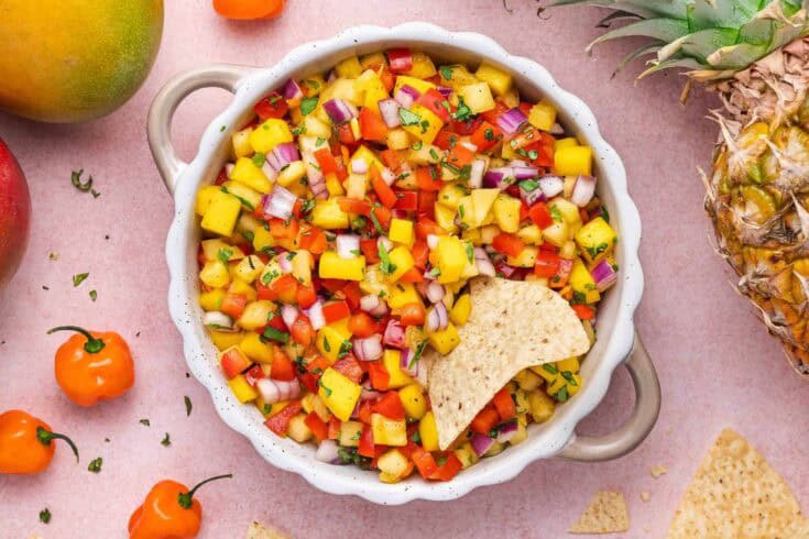 Vibrant tropical fruit salsa with mango, pineapple, and red bell peppers for a fresh vegan appetizer.