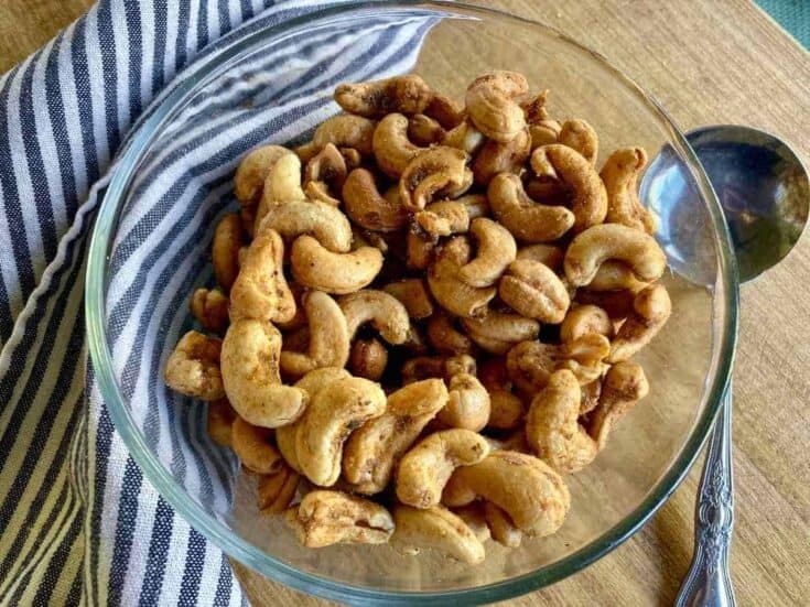 Vegan cashew nuts in a glass bowl, healthy snack option.